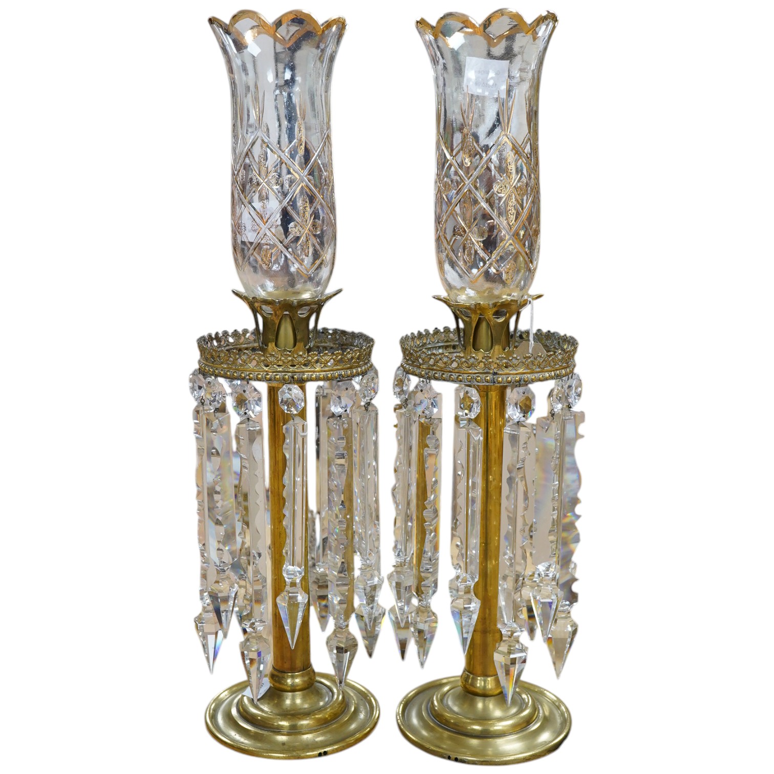 A pair of brass table lustres with storm shades, overall 63cm high, drops 21/26cm long. Condition- good